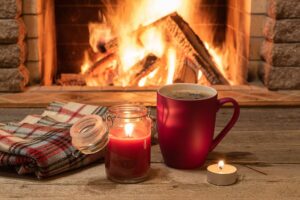 A cozy Scottish scene with a steaming mug of Hot Toddy by a fireplace